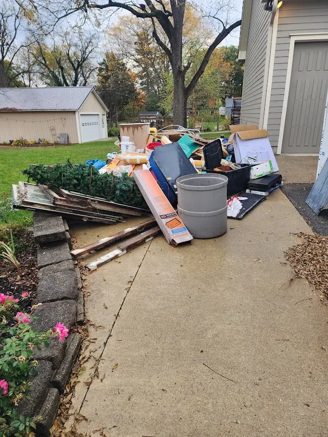Dumpster being loaded with debris for Estate Cleanout Dumpster Rental in Winchester